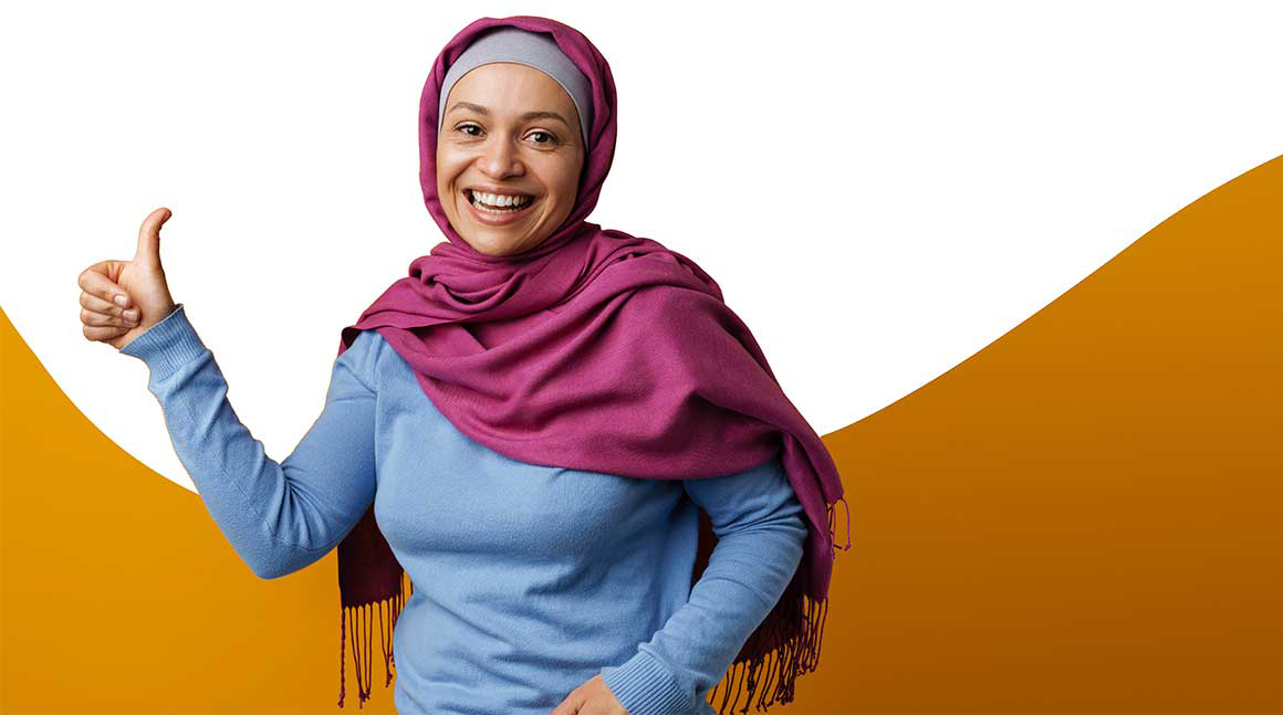 Middle eastern woman in headscarf smiling and showing thumb up